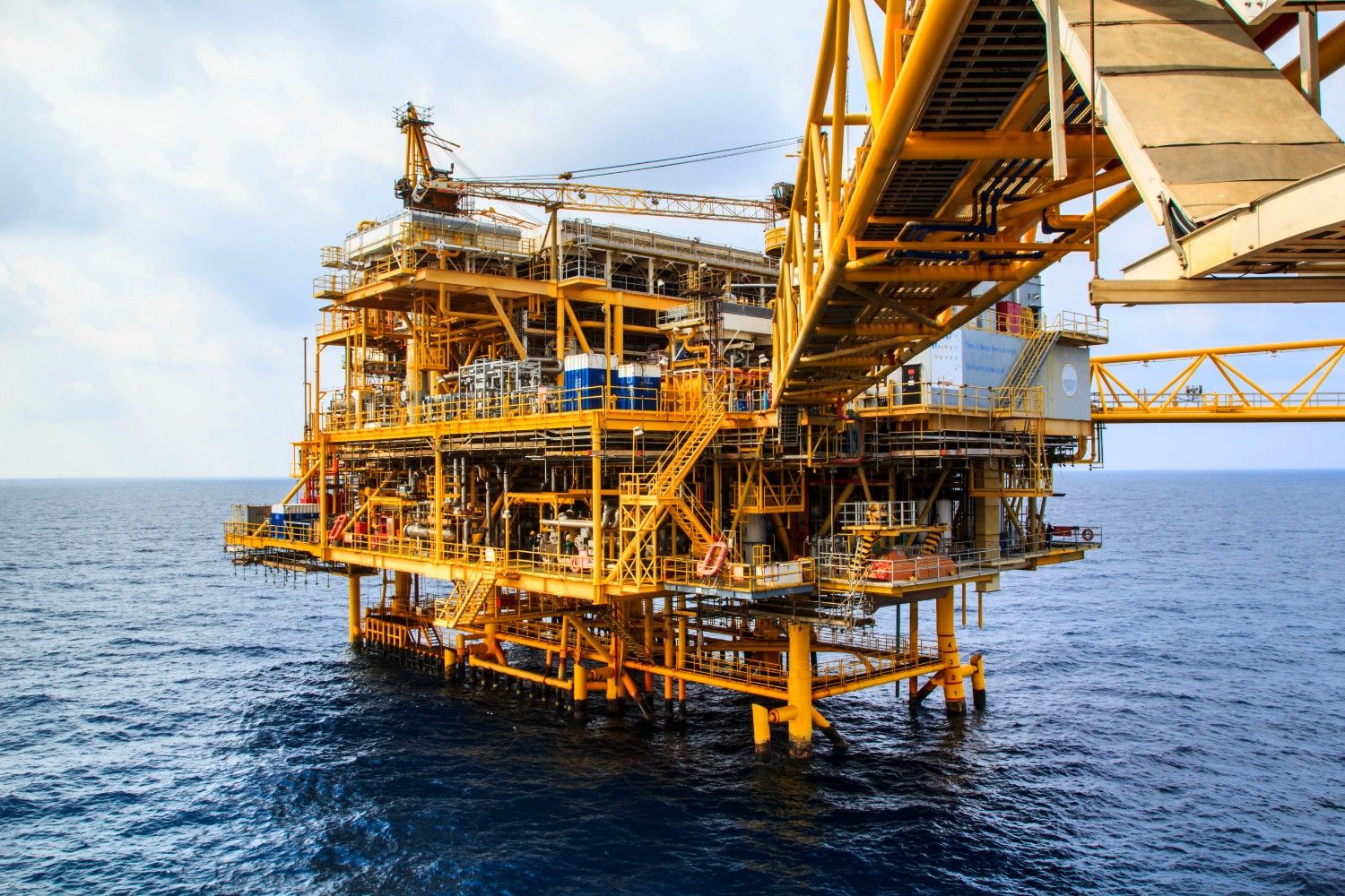 Offshore oil platform standing tall in the vast open ocean.