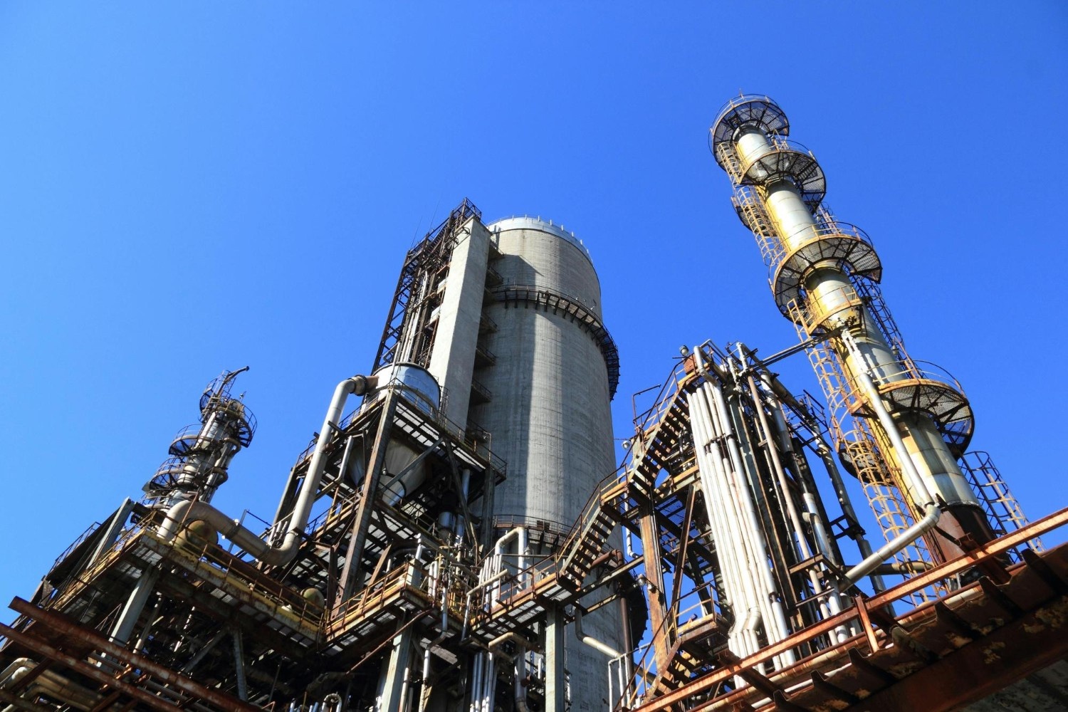 Large industrial plant with intricate network of pipes and tubes.